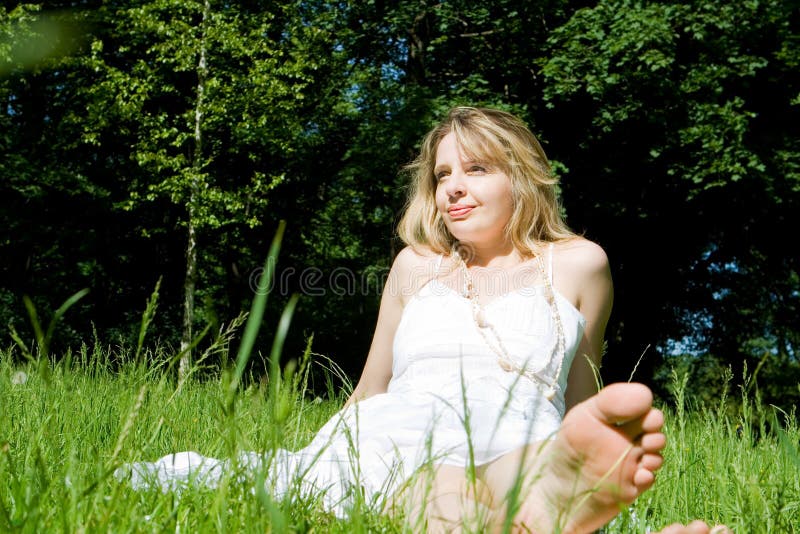 A woman sitting in a field