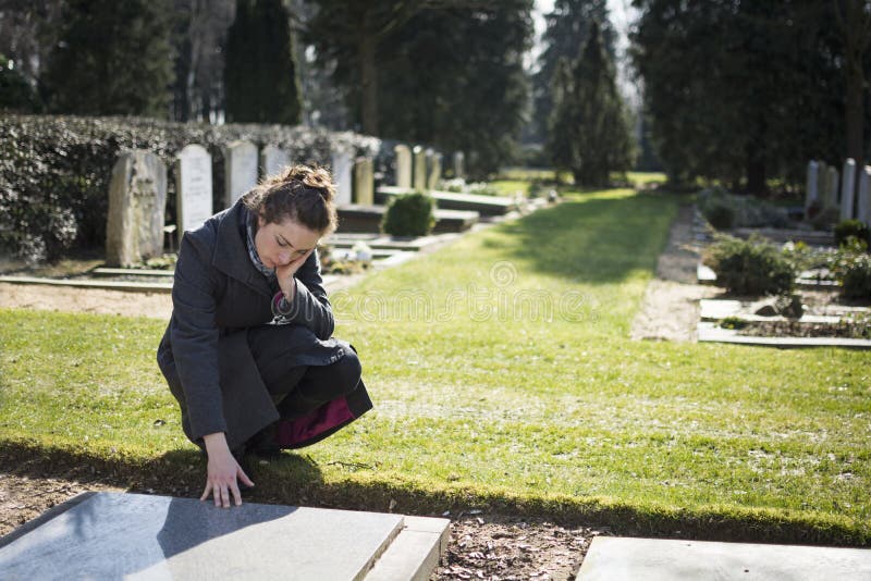 Woman sitting at grave
