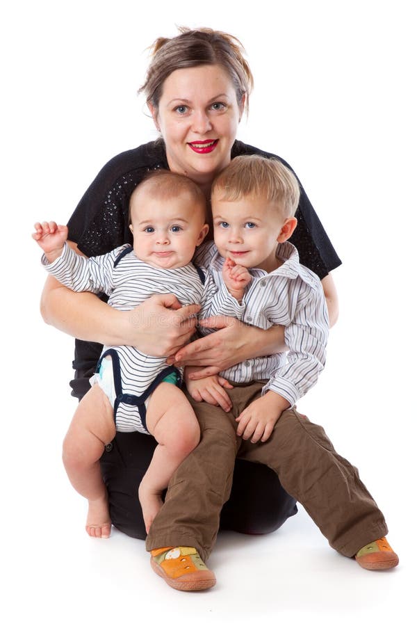 A woman is sitting with her children