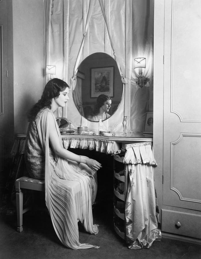 Woman sitting at her vanity table.