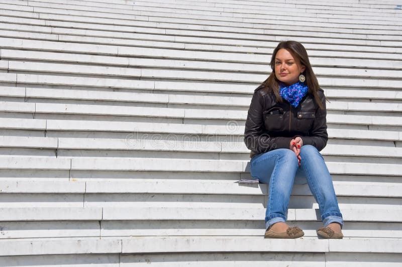 Woman sitting on the marble steps