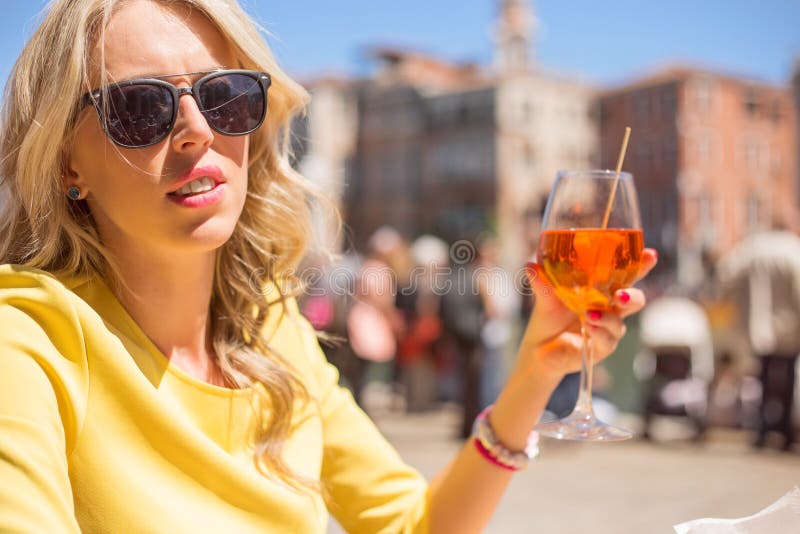 Woman Sitting in Outdoor Cafe and Drinking Aperol Spritz Cocktail Stock ...