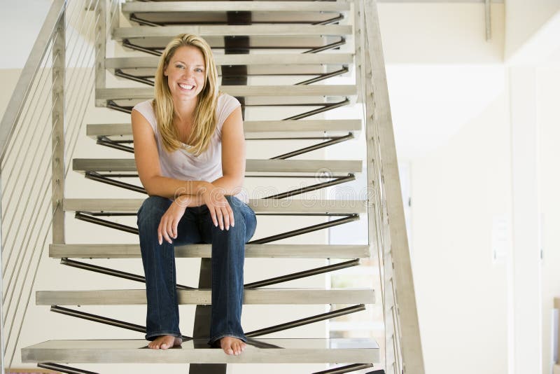 Woman sitting on stairs smiling