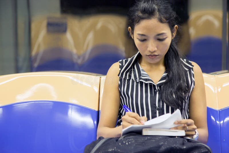 Woman sitting in the subway car stock photography
