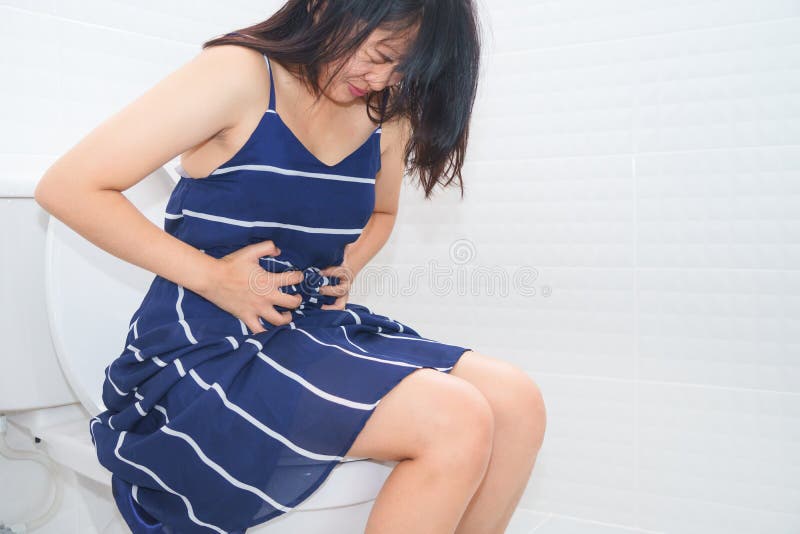 Woman sitting on toilet with diarrhea or constipated pain concept