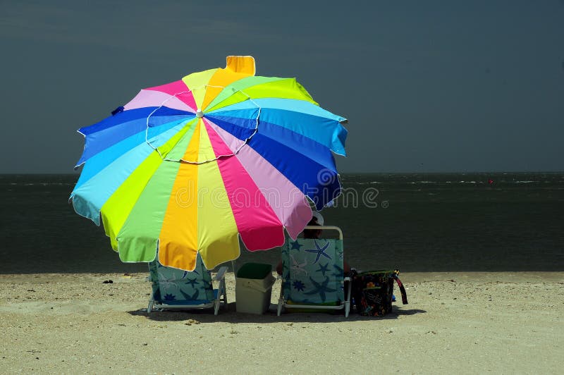 Woman sitting under colorful umbrella royalty free stock photo Woman sitting under colorful umbrella royalty free stock photo