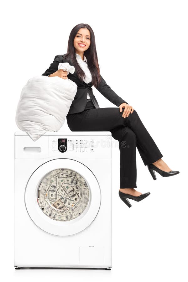 Woman sitting on washing machine full of money.