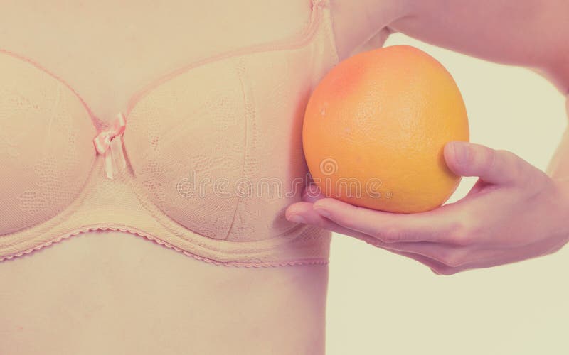 Slim Young Woman Small Boobs Puts Big Orange Fruit In Her Bra