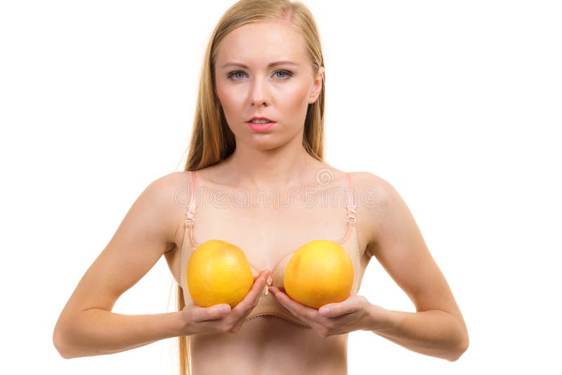 Slim Young Woman Small Boobs Puts Big Orange Fruit In Her Bra. Breast  Enlargement Size Correction Concept. Stock Photo, Picture and Royalty Free  Image. Image 174498332.