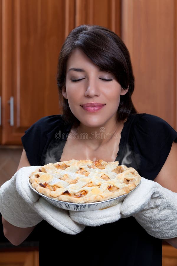 Woman smelling apple pie stock images