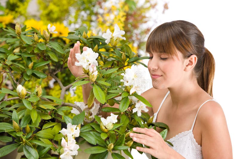 Woman smelling blossom of Rhododendron flower