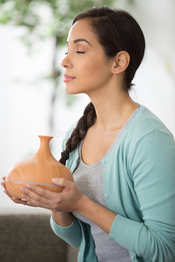 Woman smelling essential oil royalty free stock photography