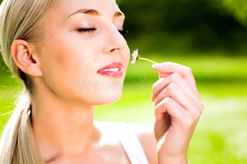 Woman Smelling Flower stock photography