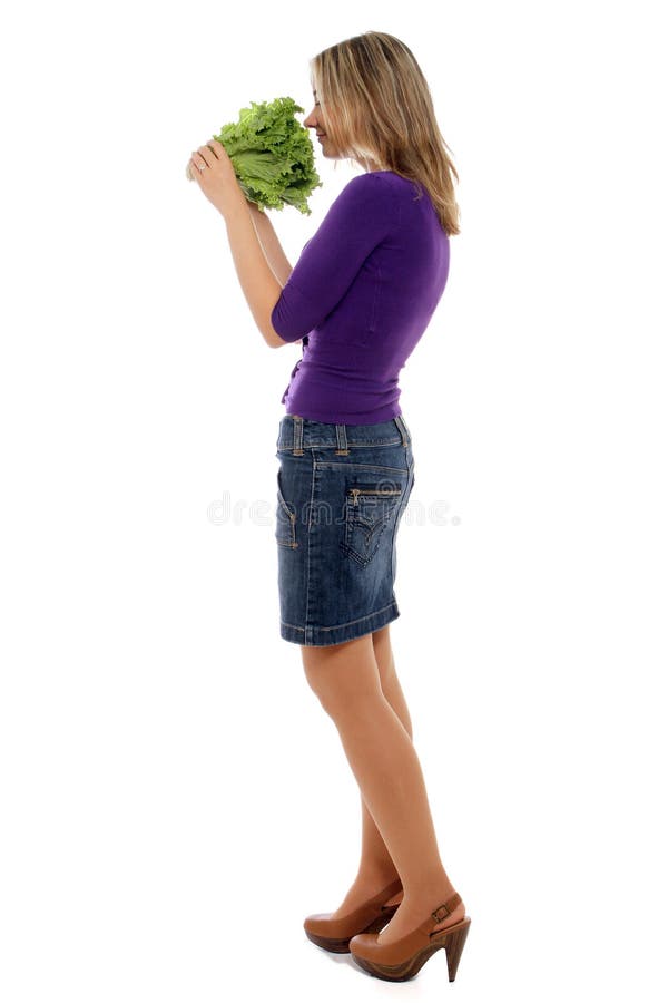 Woman smelling lettuce stock images