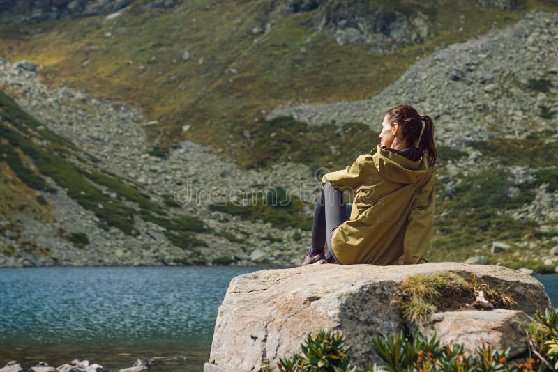 Woman Solo Traveler Looks at the Beautiful View of Mountain Lake Stock ...