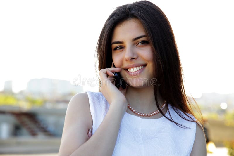 Woman speaking on the phone outdoors