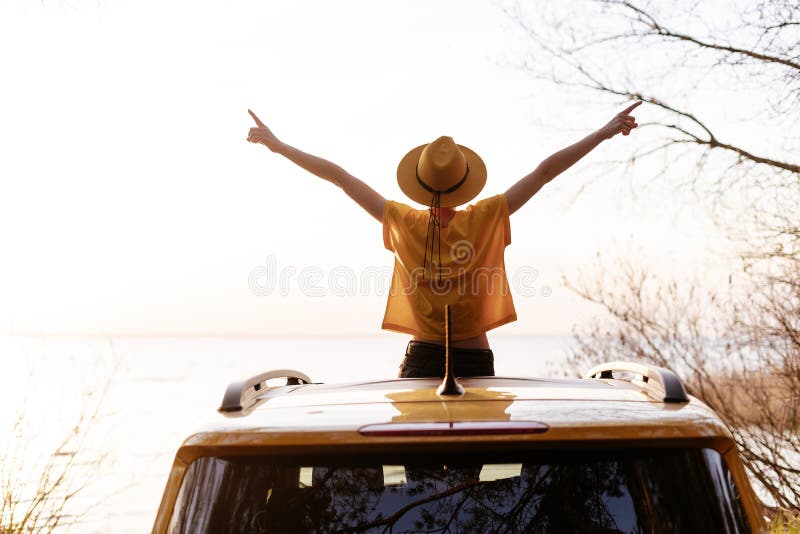 Woman Spread Arms Widely at Car Sunroof Back View