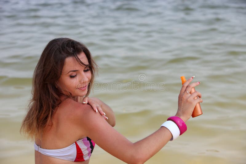 Woman spread suntan lotion