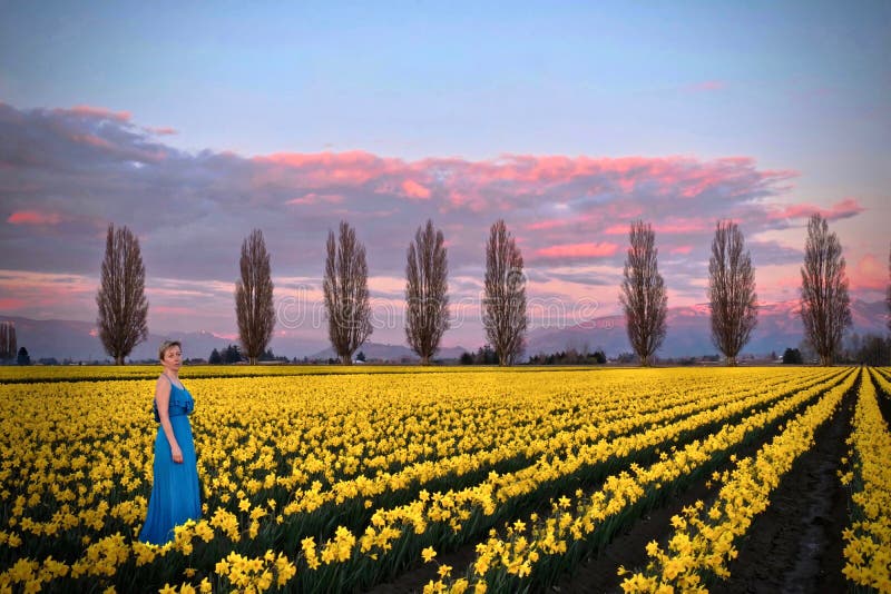 Woman in spring fields meadows with yellow flowers