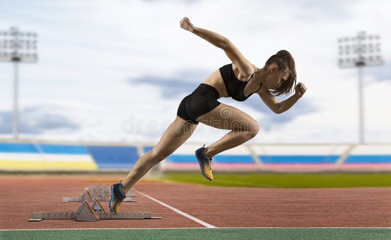 Woman sprinter leaving starting blocks on the athletic track stock photography