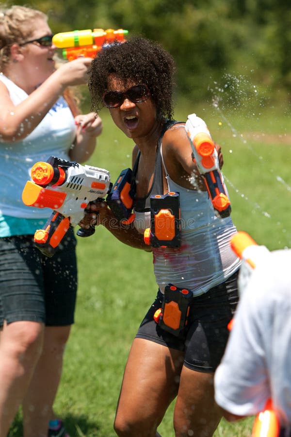Woman Squirts People In Group Water Gun Fight