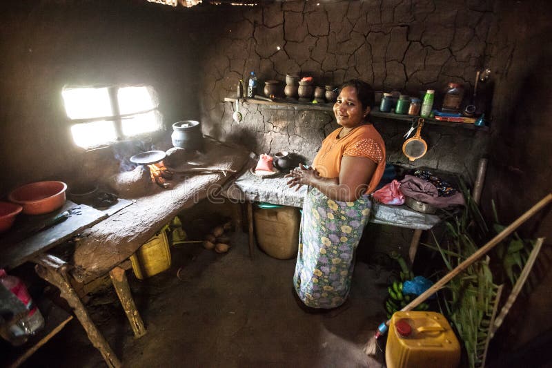 Woman in Sri Lanka in a poor kitchen.