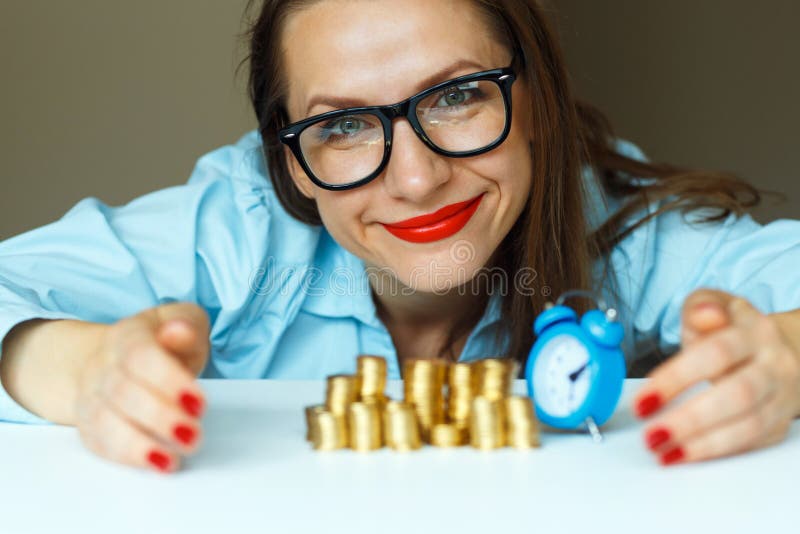 Woman stacking gold coins into columns