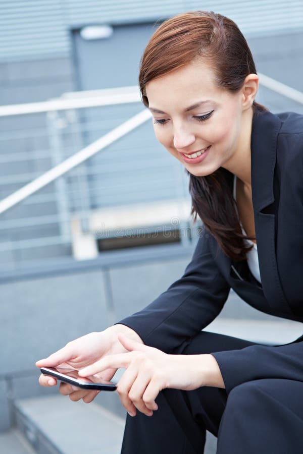 Woman on stairs using smartphone