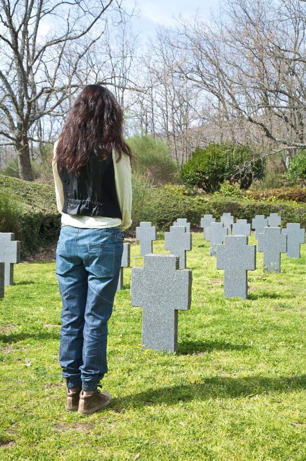 Woman stand at a cemetery