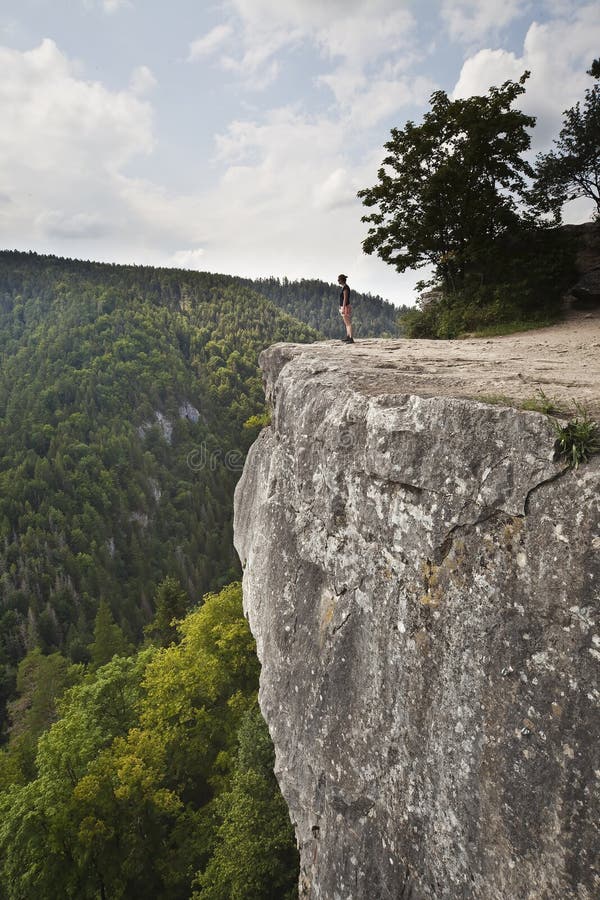 Woman standing on big rock