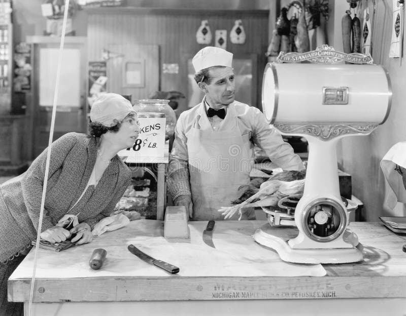 Woman standing in a butcher store looking at the scale