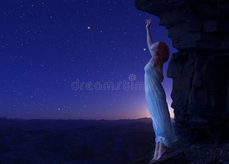 Woman standing on cliff s edge of another planet.