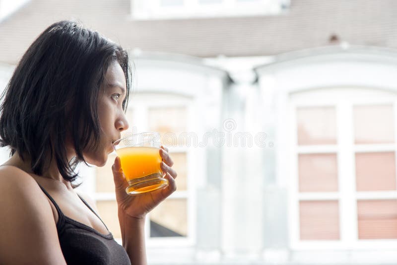 Woman standing at an open window royalty free stock photography