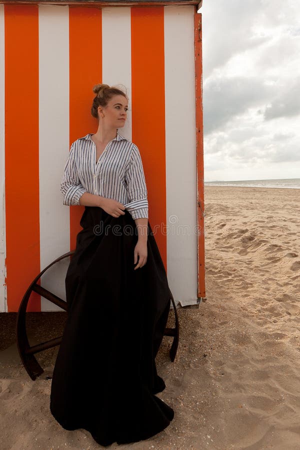 Woman sun sand hut, De Panne, Belgium