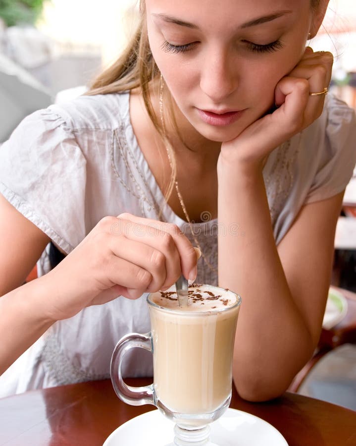 Woman is stirring coffee