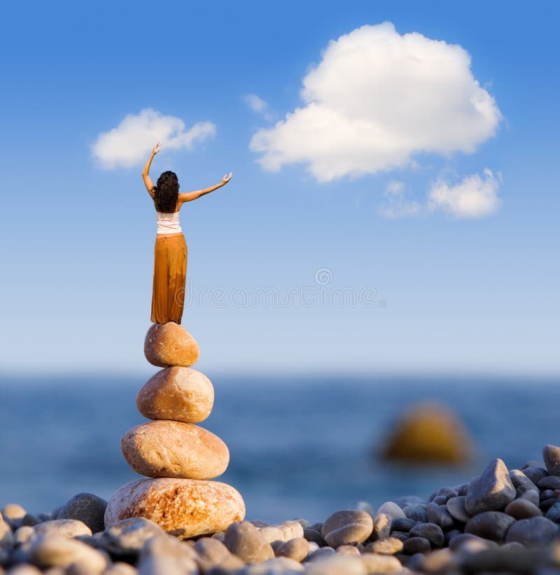 Woman and stones on the sea