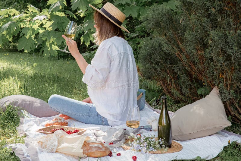 Aesthetic picnic outdoors with wine glasses bread berries and flowers.  Rustic picnic with neutral tones colours. Stock Photo by  ©lamapacas.gmail.com 378791178