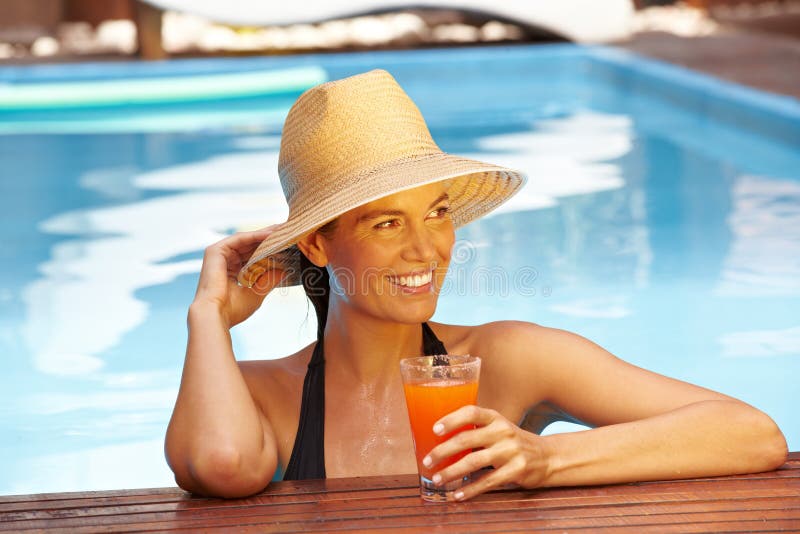 Woman with straw hat in pool