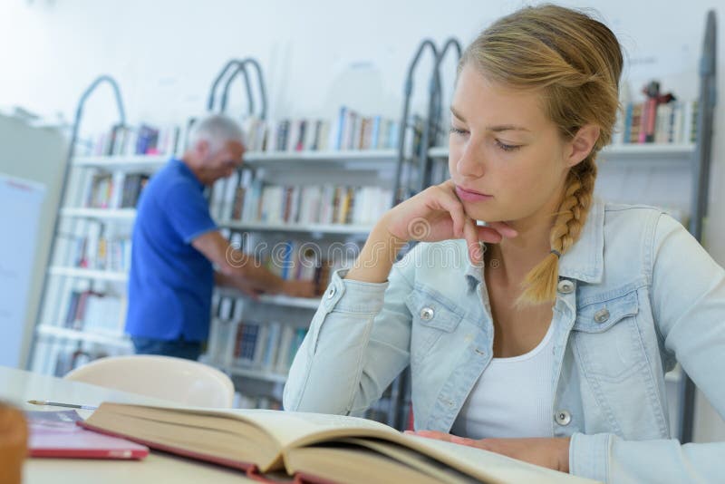 Woman studying in library royalty free stock photos