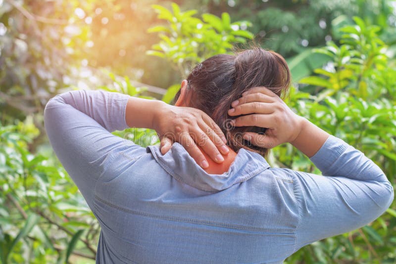 Woman suffering from neck pain at outdoor. healthy