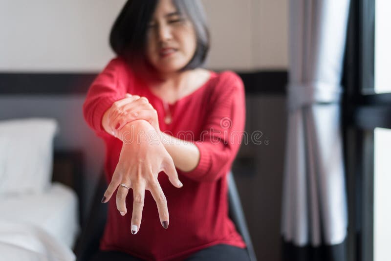 Woman suffering with Parkinson disease symptom,Selective focus hands