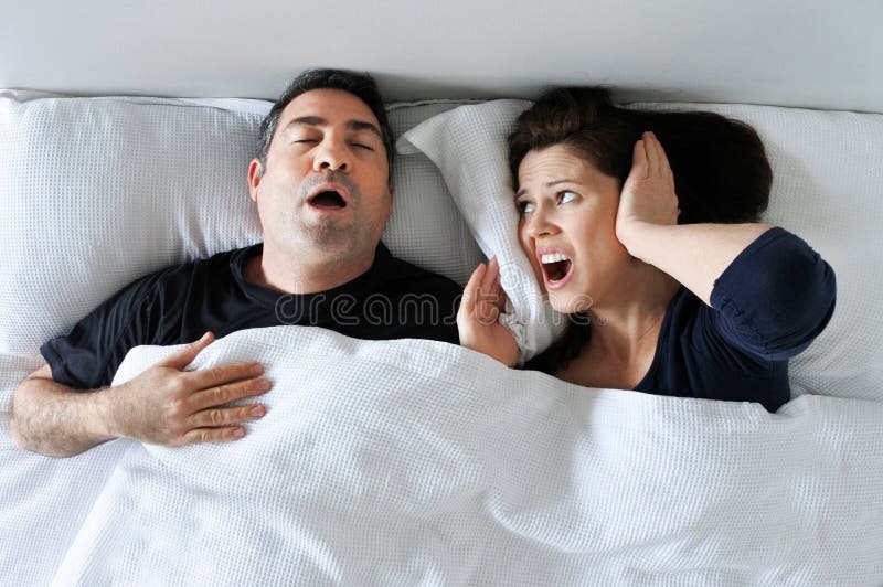 Woman suffers from her partner snoring in bed stock images Woman suffers from her partner snoring in bed stock images