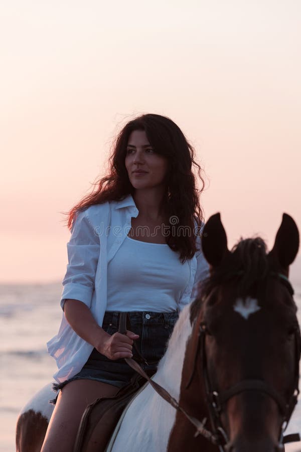 Woman in Summer Clothes Enjoys Riding a Horse on a Beautiful Sandy Beach at  Sunset. Selective Focus Stock Photo - Image of rider, horsewoman: 247112716