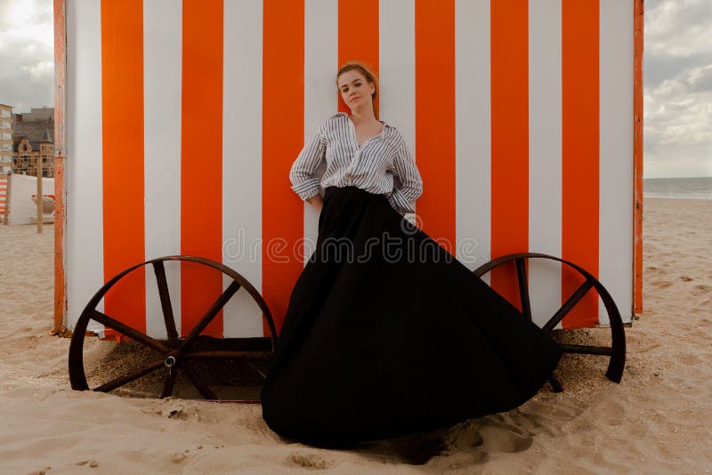 Woman sun sand hut, De Panne, Belgium