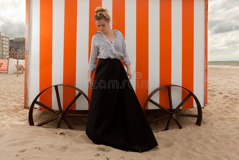 Woman sun sand hut, De Panne, Belgium