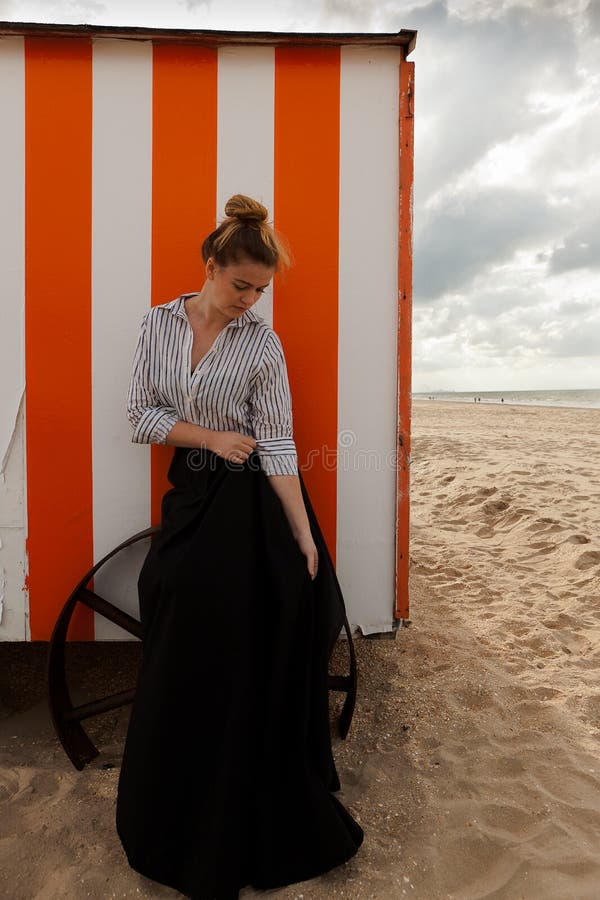 Woman sun sand hut, De Panne, Belgium