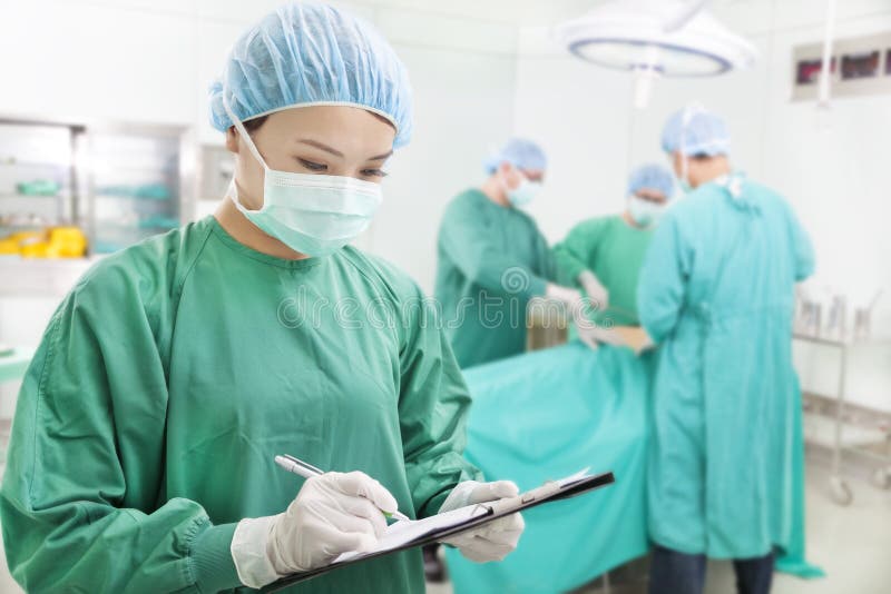 Woman Surgeons writing records on form royalty free stock photography