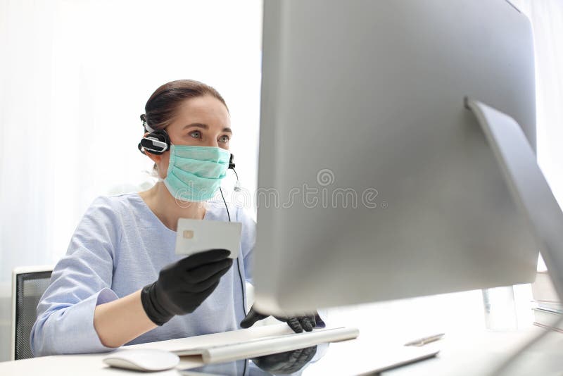 Quarantine. Working at the computer in a mask. protection of employee health. stock photos Quarantine. Working at the computer in a mask. protection of employee health. stock photos