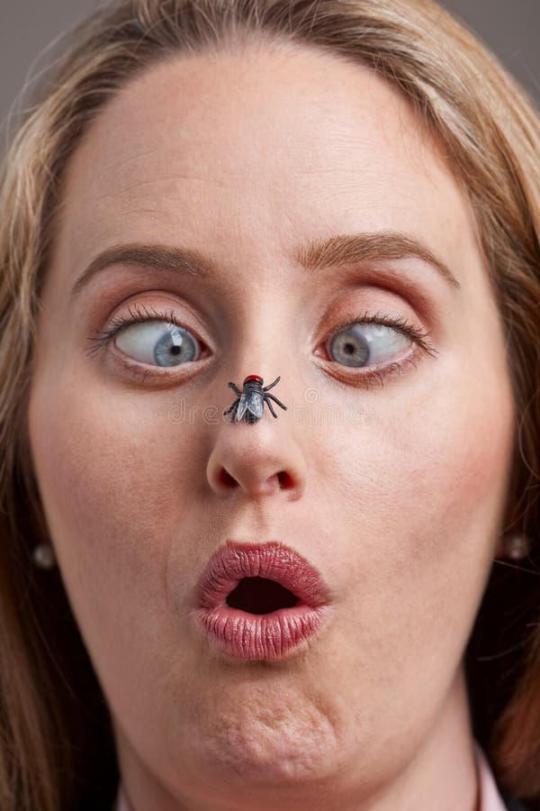 Woman surprised by fly on her nose