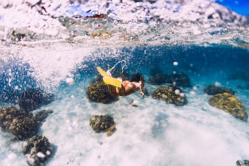 Woman Swimming Underwater In Transparent Blue Ocean At Mauritius Le